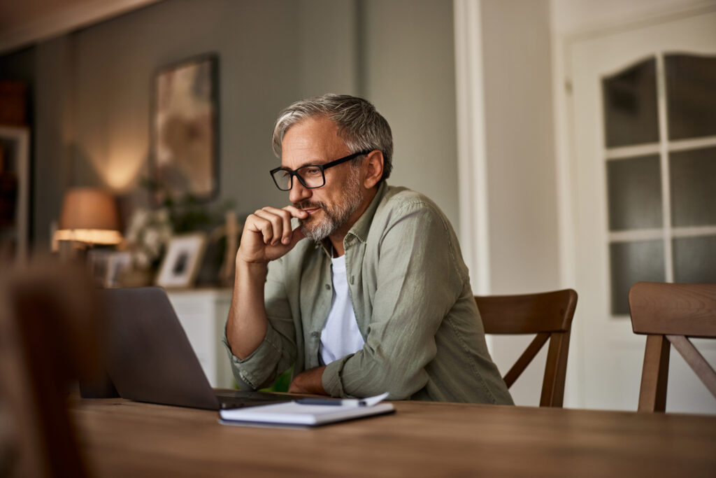 older man looking at a laptop screen
